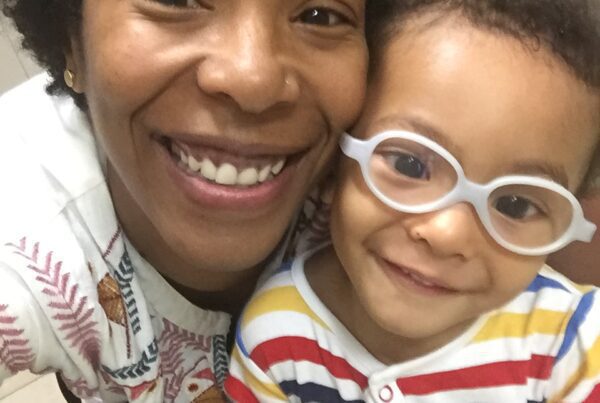 Patricia Holman helps Isaiah turn on his learning switch