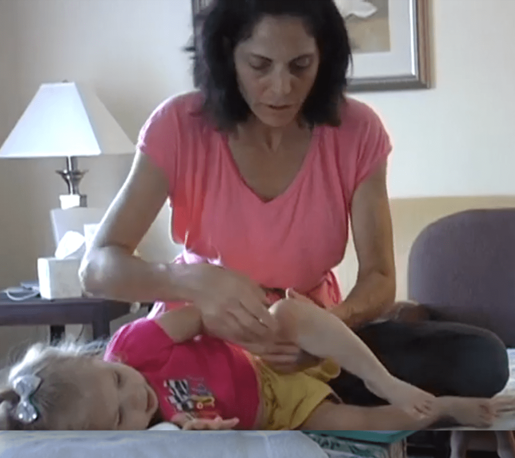 Pati guides a child through an awareness through movement series